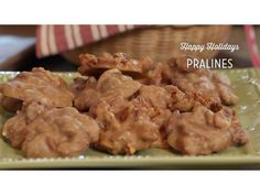 a green plate topped with meat covered in gravy next to a red and white napkin