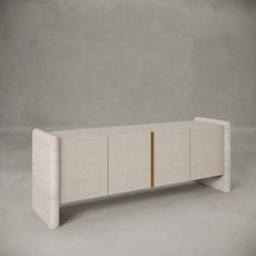 the sideboard is made out of white marble and has two gold lines on it