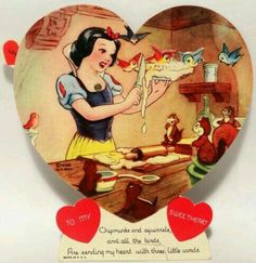 a heart shaped box with an image of snow white and the seven dwarfs