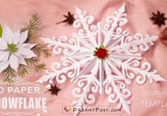 two paper snowflakes are sitting on a pink background with red and white poinsettis