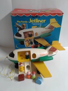 a play family jetliner in its box with other toys around it and the contents