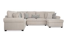 a sectional couch with pillows on it