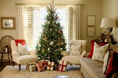 a living room with a christmas tree in the corner