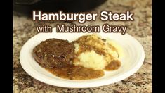 hamburger steak with mushroom gravy on a white plate