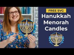 a woman holding two menorah candles in her hands