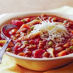 a bowl filled with pasta, beans and cheese