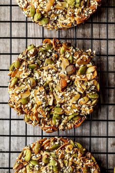 three cookies with nuts and seeds on a cooling rack