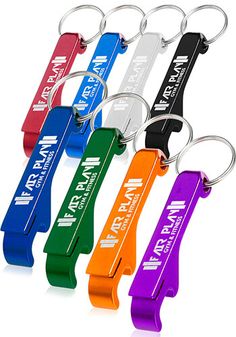 four different colored key chains with the names of each team on them, and one has a bottle opener attached to it