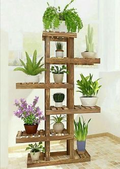 a wooden shelf filled with potted plants on top of a tiled floor next to a window