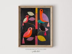 an abstract painting with birds and leaves on a black background in a wooden frame hanging on the wall