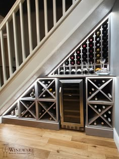 a wine cellar under the stairs in a house