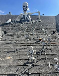 skeleton figurines on the roof of a house