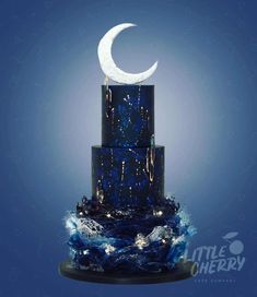 a three tiered blue cake with a crescent on top