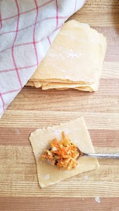 an egg roll wrapper is sitting on a cutting board