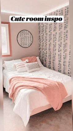 a white bed sitting under a window next to a wall mounted clock on a wall