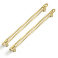 two gold colored metal handles on a white background