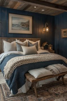 a large bed sitting under a painting on the wall next to a wooden headboard