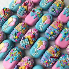 many decorated cookies sitting on top of a table