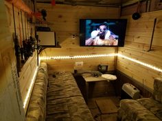 a living room filled with furniture and a flat screen tv mounted to the wall above it