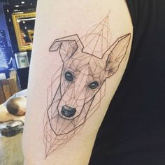 a dog's head is shown on the left side of the arm, with lines running through it