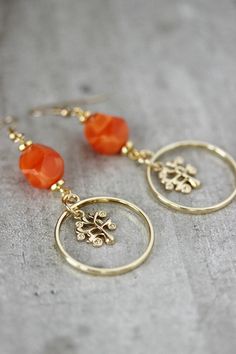 Unique feminine pair of earrings was made of bright orange faceted beads, open circle gold tone charms, gold tone tree charms,gold tone separators, gold tone (brass base) earring hooks. Earring hooks are from nickel free and lead free metal. Wonderful jewelry for you or a great gift for someone special! *The total lenght of earrings is about 67 mm. Other earrings of my shop you can see here: https://www.etsy.com/shop/NaTavelli?section_id=13757927 Thanks for visit. Gold Czech Glass Dangle Flower Earrings, Gold Nickel-free Czech Glass Flower Earrings, Gold Czech Glass Flower Earrings For Gift, Nickel-free Gold Czech Glass Flower Earrings, Nickel-free Gold Flower Earrings With Czech Glass, Gold Dangle Flower Earrings With Czech Glass, Nickel Free Gold Earrings With Czech Glass, Gold Round Beads Flower Earrings As Gift, Nickel-free Gold Earrings With Czech Glass