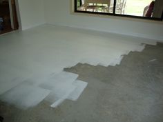 an empty room with white paint on the floor