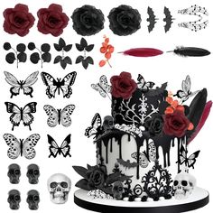 a cake decorated with black and white icing next to skulls, roses and feathers