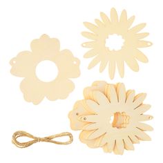 three wooden flower shapes and a string on a white background