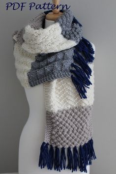 a white mannequin wearing a gray and blue scarf