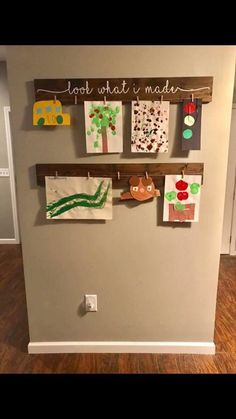 the wall is decorated with pictures and magnets for kids's art work on it