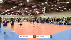 people are playing volleyball in an indoor gym