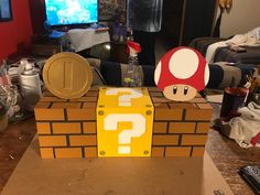 a cardboard mario mushroom sitting on top of a table next to a nintendo wii game controller