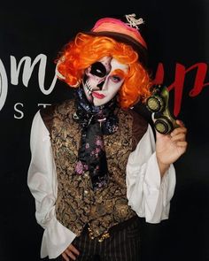 a man with orange hair wearing a clown mask and holding a clock in his right hand