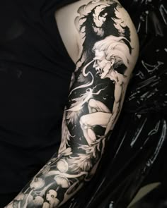 a man with a black and white tattoo on his arm