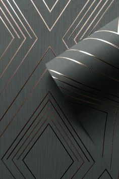 an abstract wallpaper with gold lines and triangles on grey paper, which is also available in various colors