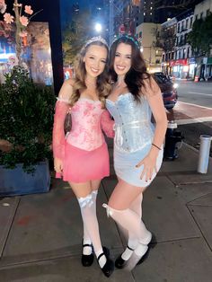 two women dressed in costumes posing for the camera