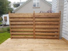 a large wooden fence on the side of a house