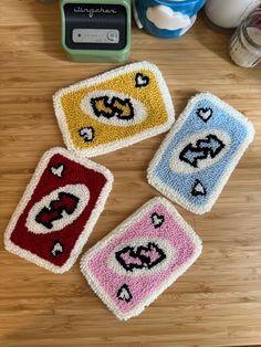 three crocheted coasters sitting on top of a wooden table