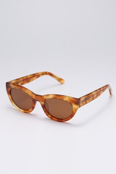 Frame: Brown tortoiseshell acetate Lenses: Brown Lenses: 52 mm, Bridge: 22 mm, Temples: 150 mm Brown tortoiseshell-acetate sunglasses shaped to an elegant cat-eye silhouette, offering a mix of functionality and retro elegance. They're made with brown tinted lenses for good UV protection.