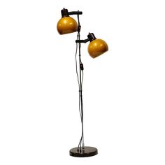 two light floor lamp with black base and gold shades on the lampshades,