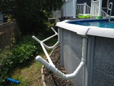 an above ground swimming pool with pipes attached to it