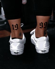 a woman's foot with a small tattoo on her left ankle and the word up written in cursive letters