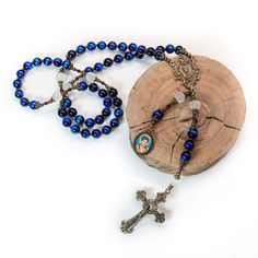 ♦ ITEM DESCRIPTION ♦ Designed with a young man's confirmation in mind, this beautiful heirloom quality and vintage-looking catholic rosary. Feel confident you're ordering a beautiful rosary by looking at my shop reviews.   This rosary is made of 8mm rich blue tiger eye Hail Mary beads and an 8mm frosted quartz Our Father gemstone bead and is finished with bronze metal findings. The bronze medals are heirloom quality bronze reproductions with a custom picture medal of Blessed Carlos Acutis.  This Spiritual Rosary With Crucifix For First Communion, Spiritual Rosary For First Communion, Spiritual Crucifix Rosary For First Communion, First Communion Spiritual Rosary With Crucifix, Spiritual Rosary With Miraculous Medal And Crucifix, Adjustable Spiritual Rosary With Miraculous Medal, Adjustable Rosary With Miraculous Medal And Crucifix, Blessed Carlo Acutis, Metallic Wrapping Paper