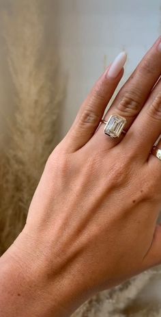 a woman's hand with two rings on it