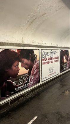 an advertisement on the side of a wall with two people kissing and another person standing next to it