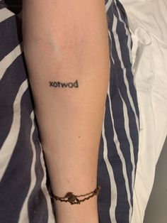 a woman with a tattoo on her arm that says bowtox in black ink