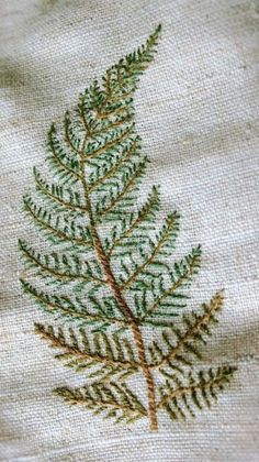 a close up of a leaf on a piece of cloth