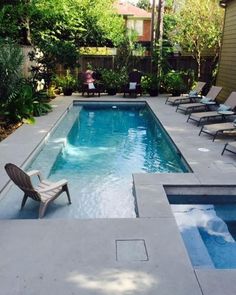 an empty swimming pool surrounded by lawn chairs