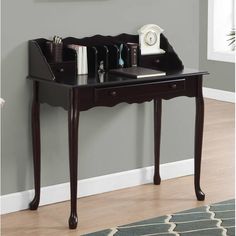 a wooden desk with two drawers and a clock on the top shelf next to it