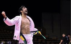 a man with no shirt on standing in the middle of a court holding his arms out